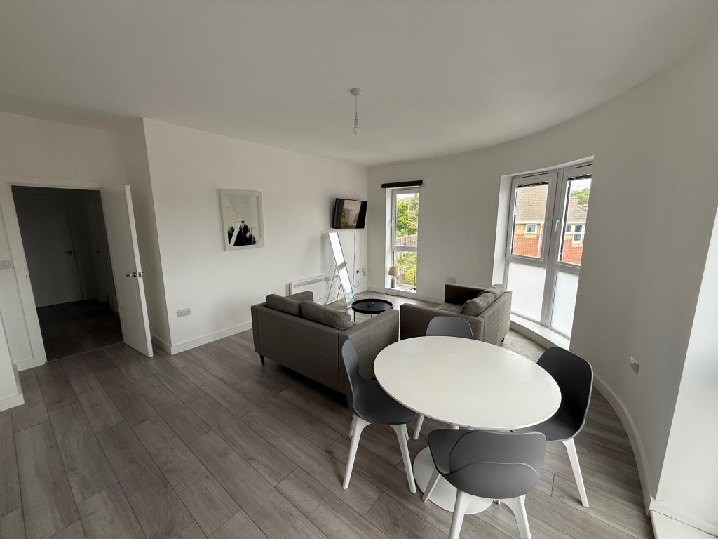 Lot: 128 - FLAT FOR INVESTMENT - Living room with white painted walls and grey flooring